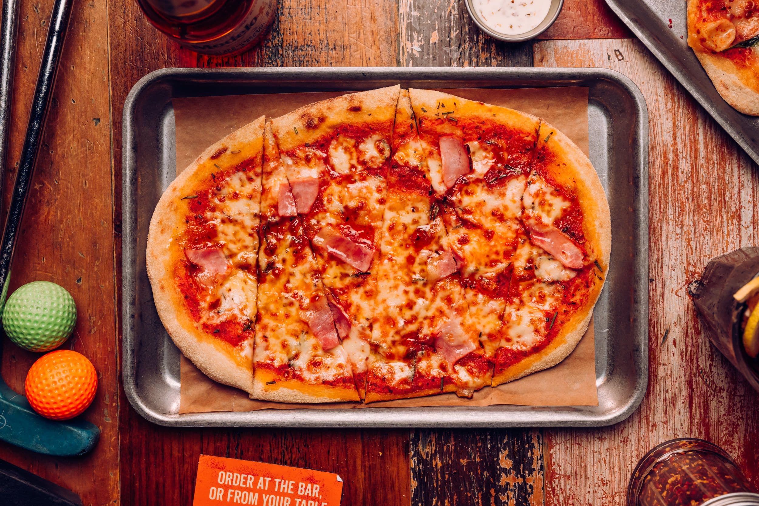A maple slice festive pizza displayed on a table at Treetop Golf.